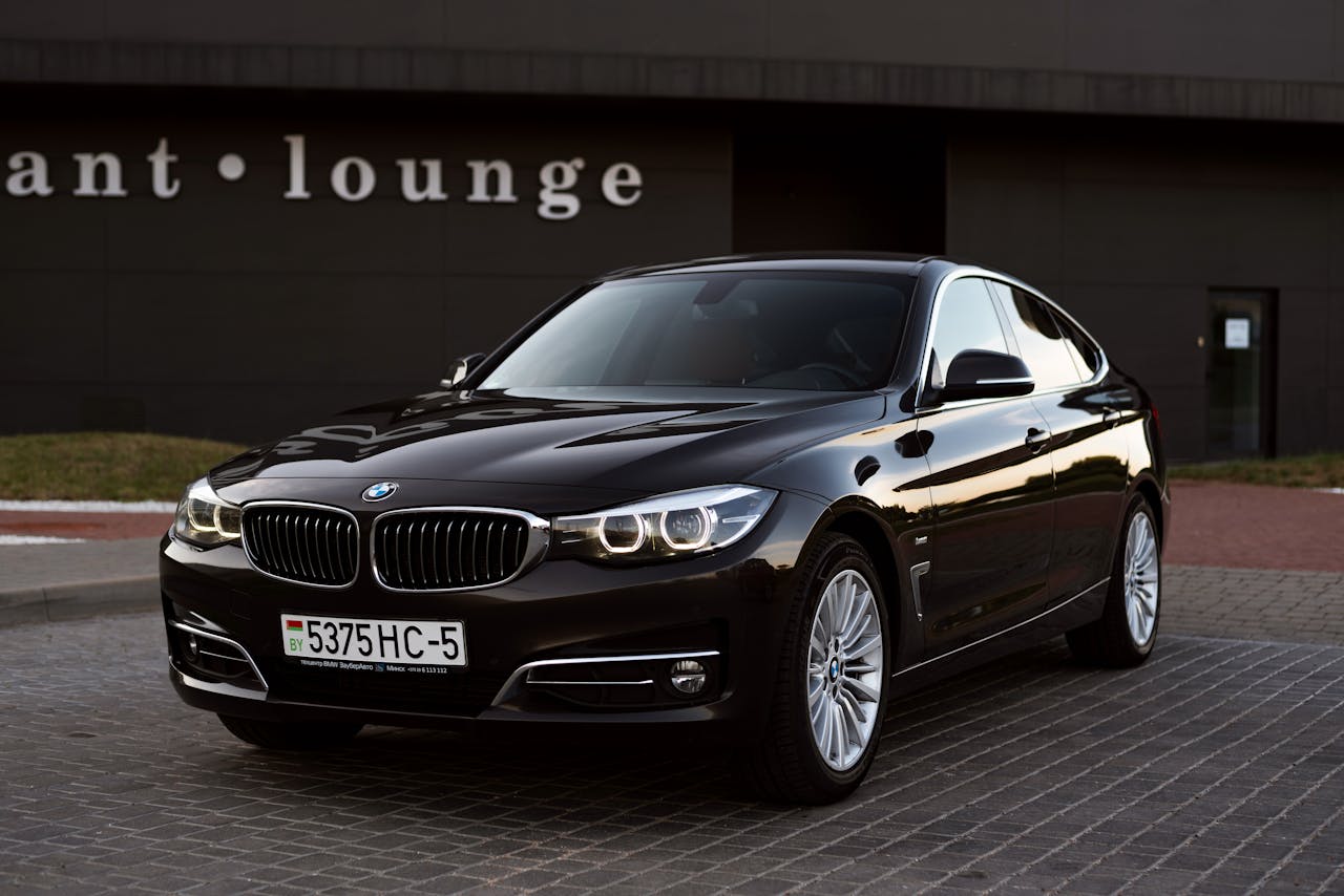 Luxury black BMW parked outside lounge offers a sleek and modern look. Perfect for automotive enthusiasts.