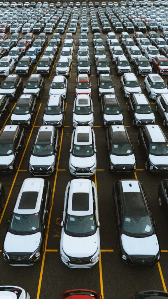 Crafting Captivating Headlines: Your awesome post title goes here Aerial view of numerous cars in a parking lot, showcasing lined automobiles for sale or storage.